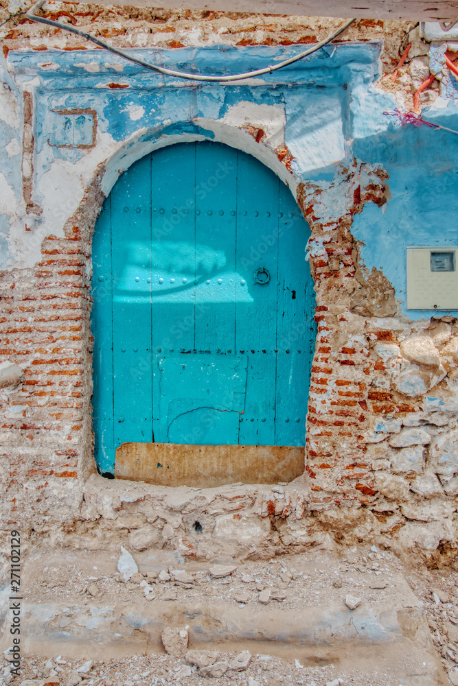 Very old door of a facade in ruins Very old door of a facade in ruins