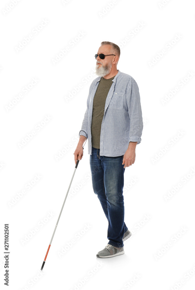 Mature blind person with long cane walking on white background Stock Photo