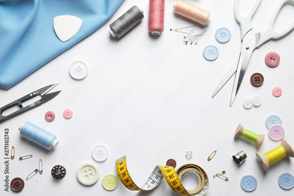 Flat lay composition with scissors and sewing supplies on white background. Space for text Flat lay composition with scissors and sewing supplies on white background. Space for text