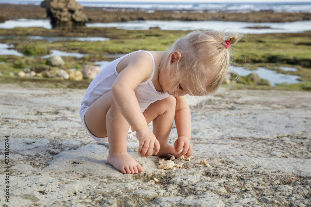Candid portrait of a happy child enjoying a day at the rocky beach Candid portrait of a happy child enjoying a day at the rocky beach