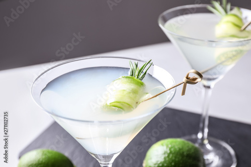 Glasses of cucumber martini on table against dark background, closeup. Space for text