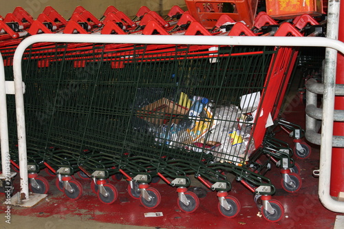 Red shopping trolleys stacked full of dirt trash 