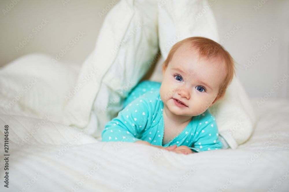 Cute little girl playing with pillows on bed Cute little girl playing with pillows on bed