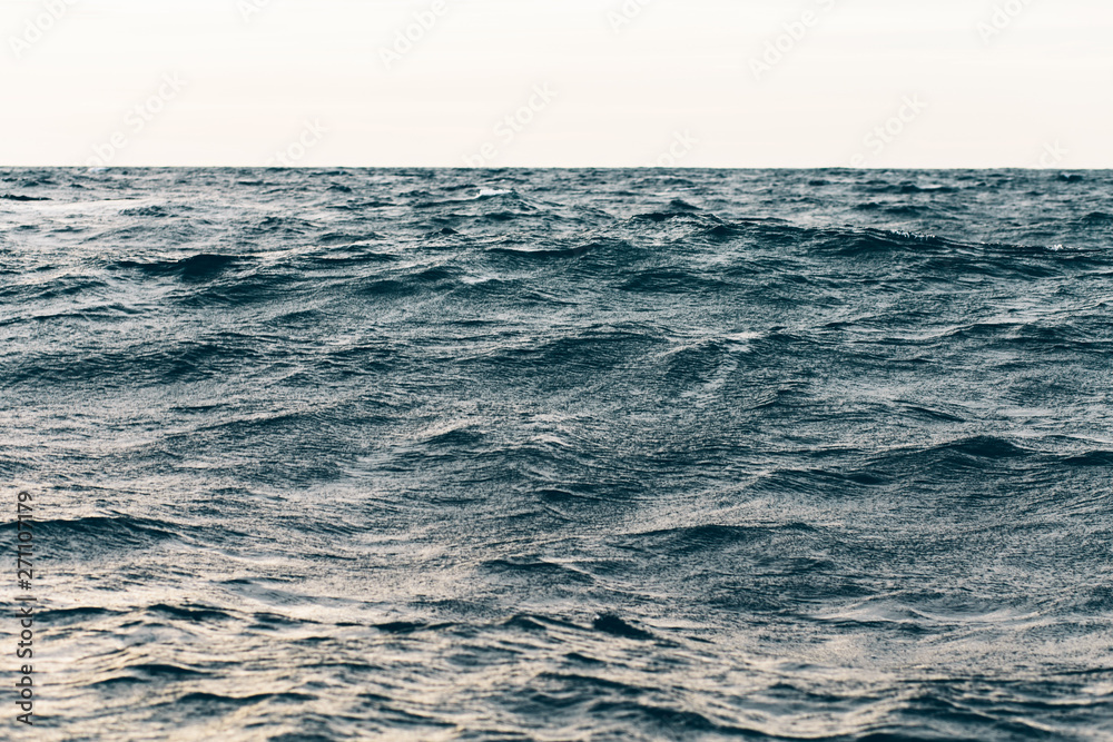dark blue sea water background, waves of blue in black sea