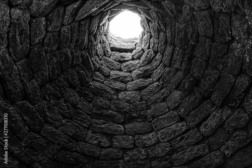 Deep ancient well inside photo