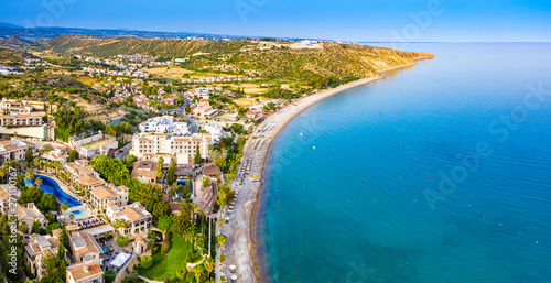 Pissouri. Cyprus Republic. Pissouri beach in a sunny day panorama from a drone. Residential settlements on the Mediterranean sea coast. The picturesque blue bay. The Pissouri resort. Travel to Cyprus. photo