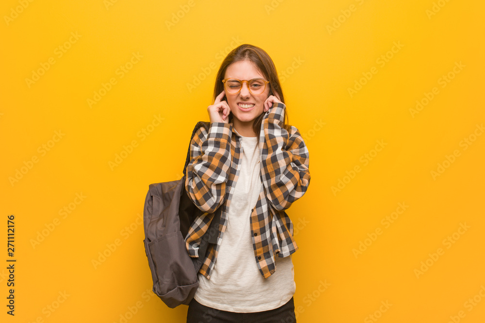 Young student woman covering ears with hands Young student woman covering ears with hands
