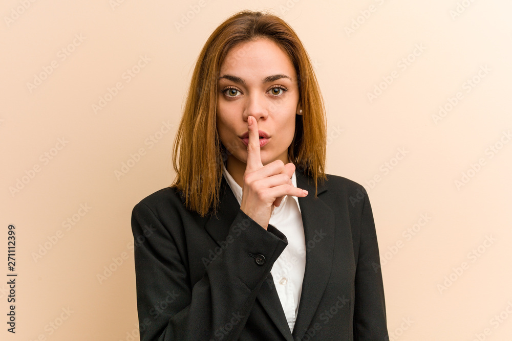 Young caucasian business woman keeping a secret or asking for silence. Young caucasian business woman keeping a secret or asking for silence.