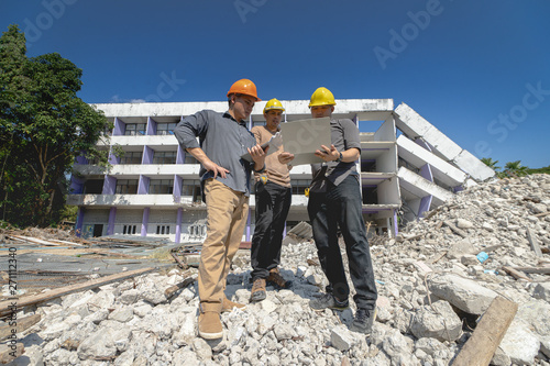 Engineer team and worker checking blueprint for emolition construction plan and inspect at the site.