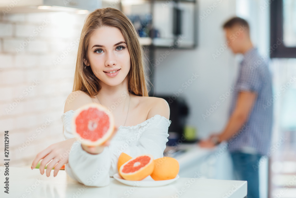Woman with long hair girl colorful eyes makeup holding grapefruit citrus ..Healthy diet food. Woman with long hair girl colorful eyes makeup holding grapefruit citrus ..Healthy diet food.