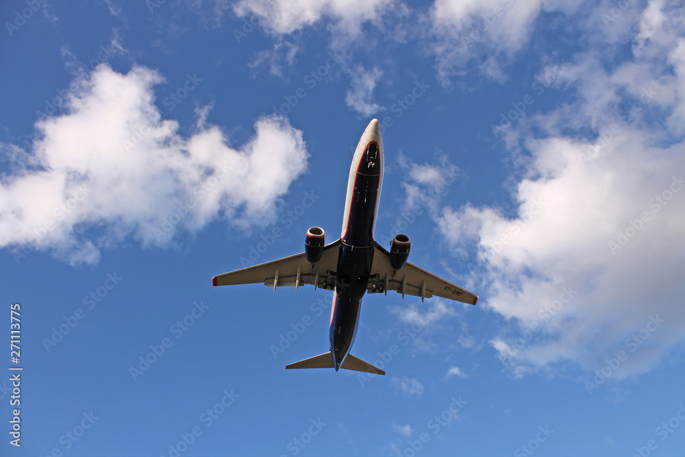 Flying plane in the blue sky with clouds Flying plane in the blue sky with clouds