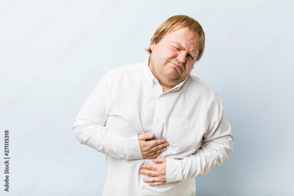 Young authentic redhead fat man sick, suffering from stomachache, painful disease concept. Young authentic redhead fat man sick, suffering from stomachache, painful disease concept.