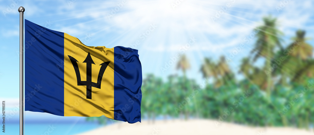 Waving Barbados flag in the sunny blue sky with summer beach background. Vacation theme, holiday concept. - obrazy, fototapety, plakaty 