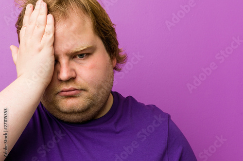 Young authentic redhead fat man forgetting something, slapping forehead with palm and closing eyes Fototapet