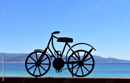 Beach with black iron bicycle. Galicia, Spain.