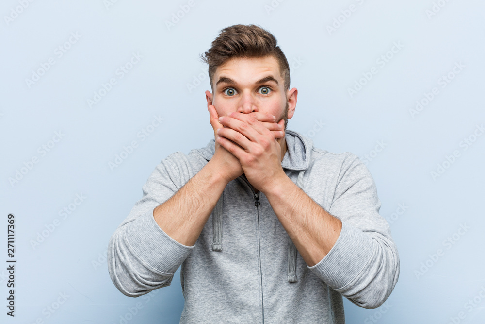 Young handsome fitness man shocked covering mouth with hands. Young handsome fitness man shocked covering mouth with hands.