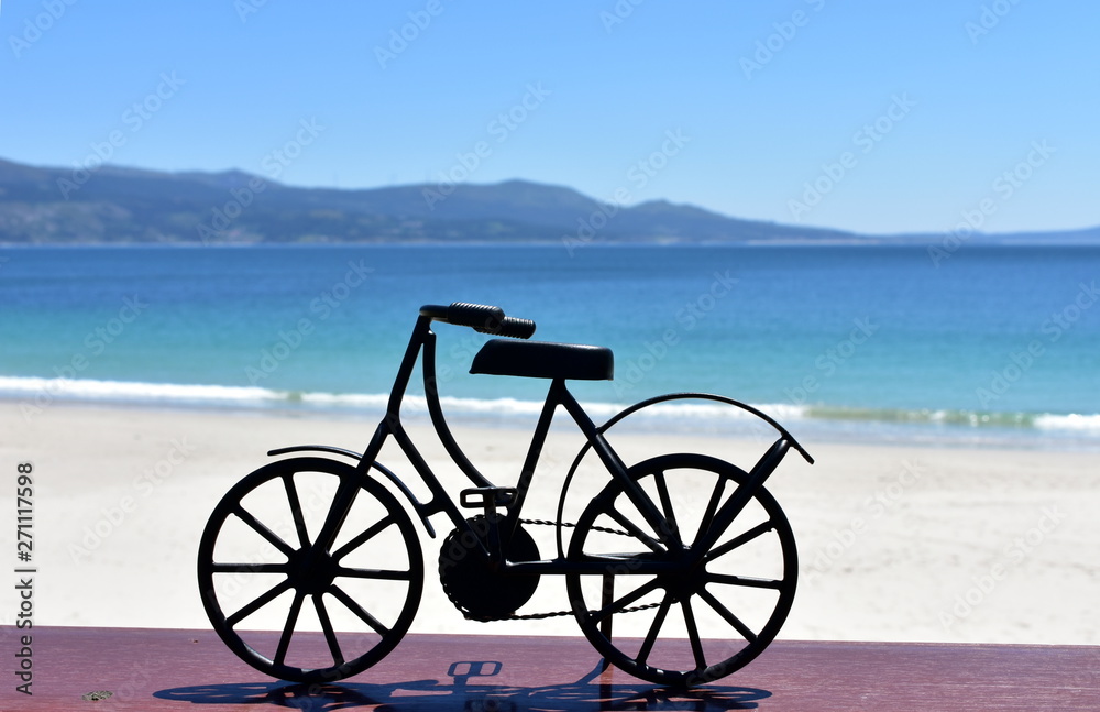 Fototapeta premium Beach with black iron bicycle. Galicia, Spain.