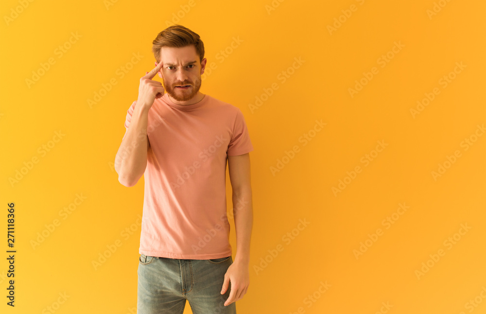 Young redhead man doing a disappointment gesture with finger Young redhead man doing a disappointment gesture with finger