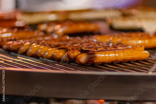 Process of cooking hotdogs at street food festival. Outdoor cooking service gastronomy and takeaway food concept