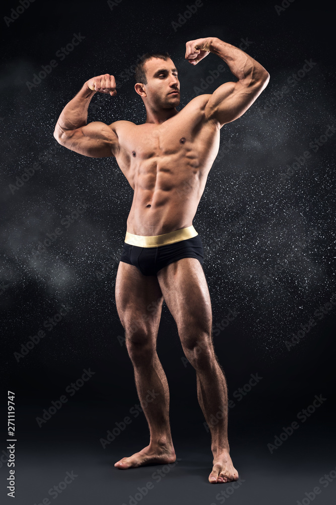 Strong millennial man showing his big muscles on camera Strong millennial man showing his big muscles on camera