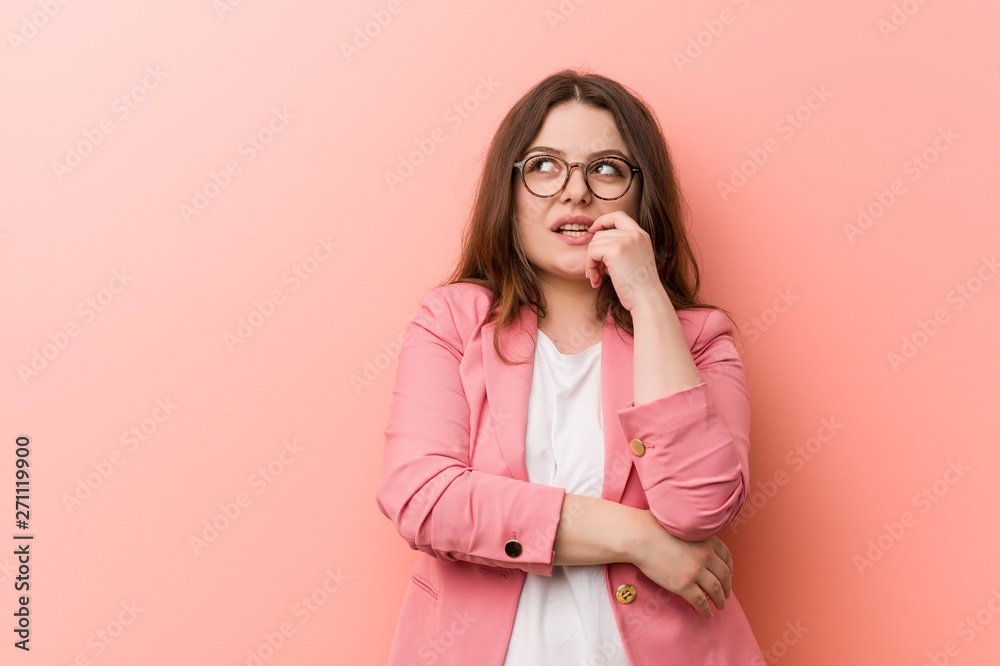 Young plus size business caucasian woman relaxed thinking about something looking at a copy space. Young plus size business caucasian woman relaxed thinking about something looking at a copy space.