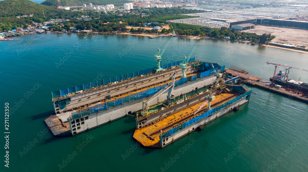 Aerial view shipyard have crane machine and container ship in black ocean