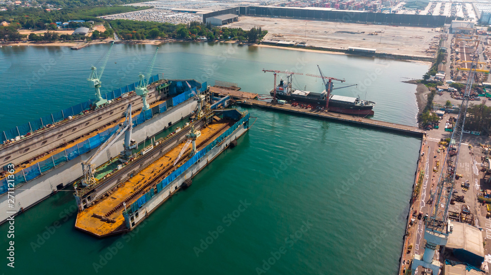 Aerial view shipyard have crane machine and container ship in black ocean