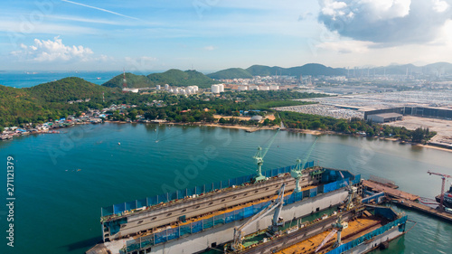 Aerial view shipyard have crane machine and container ship in black ocean