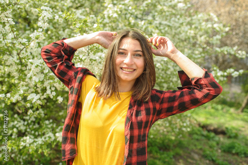 Happy girl walks down the street in spring around the city