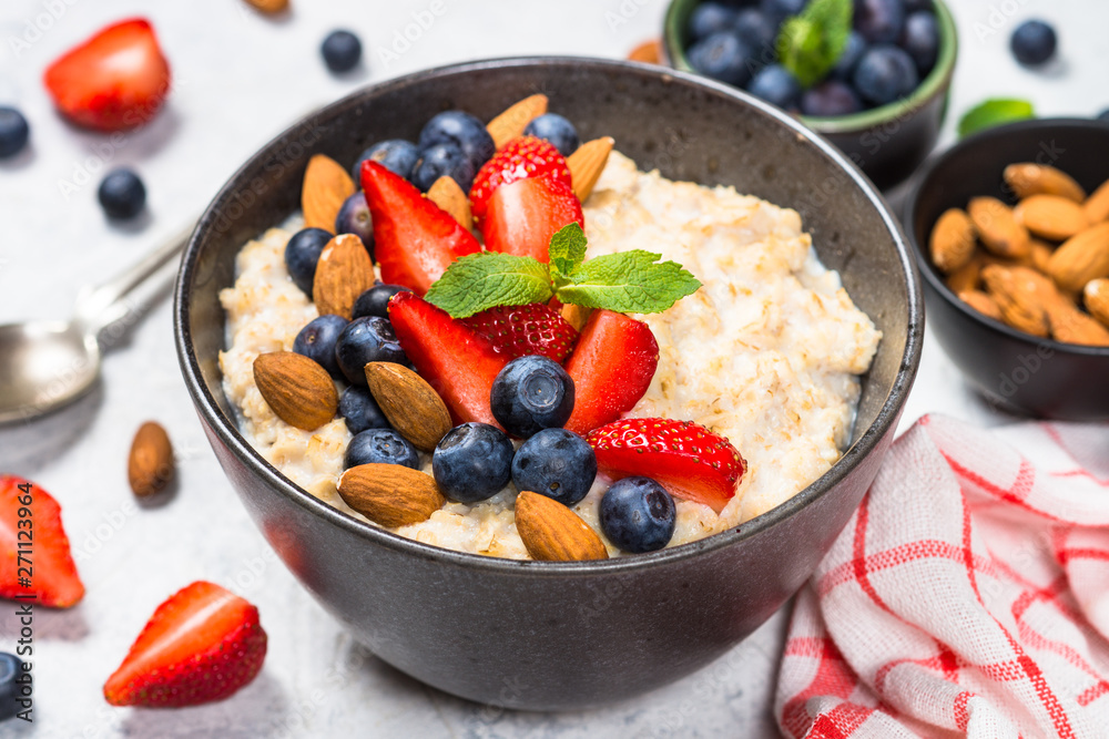 Oatmeal porridge with fresh berries and nuts. Oatmeal porridge with fresh berries and nuts.