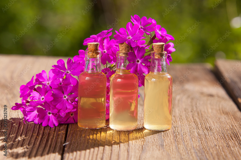 primrose essential oil in beautiful bottle on table primrose essential oil in beautiful bottle on table