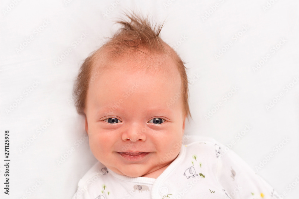 Cute Smiling newborn baby boy. Adorable infant looking at camera. Copy space Cute Smiling newborn baby boy. Adorable infant looking at camera. Copy space
