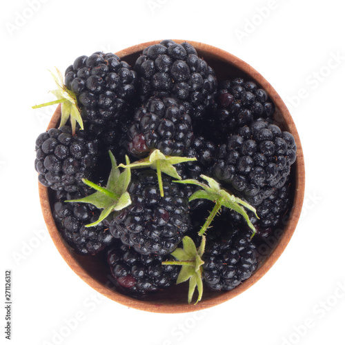 heap of blackberry in wooden cup isolated on white background