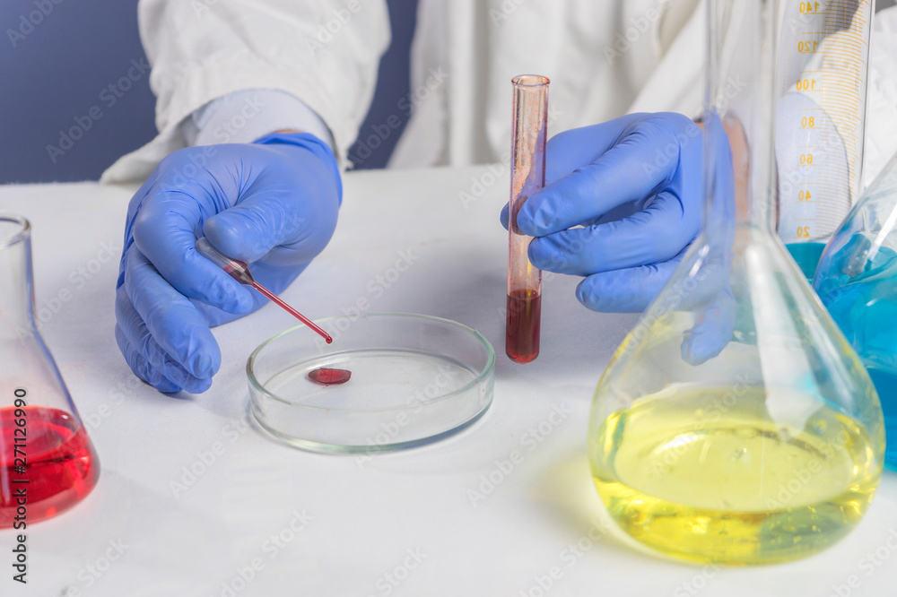 Technician holds laboratory blood panel sample test tube Technician holds laboratory blood panel sample test tube