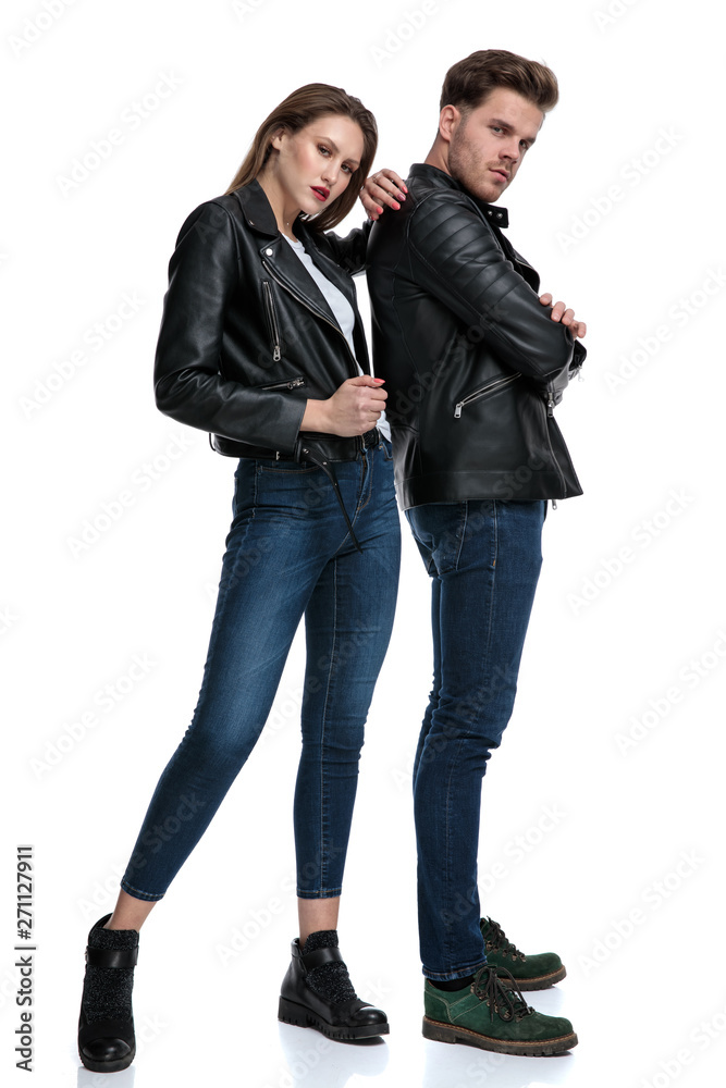 Tough couple posing while standing and looking to the camera