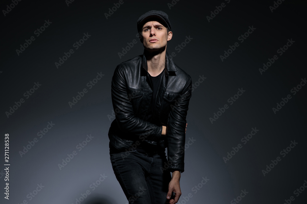 Artistic man posing as powerless and looking to the camera Artistic man posing as powerless and looking to the camera