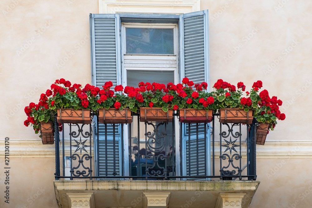 beautiful cosines balcony with flowers and blue shutters