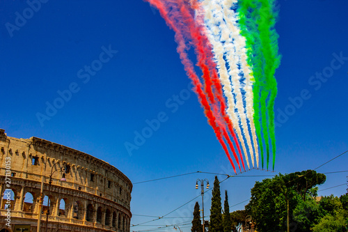 Rome, Italy, 02 / June / 2019. For the feast of the republic, the tricolor arrows (representing the Italian flag) fly over the Colosseum and the Imperial Forums.
