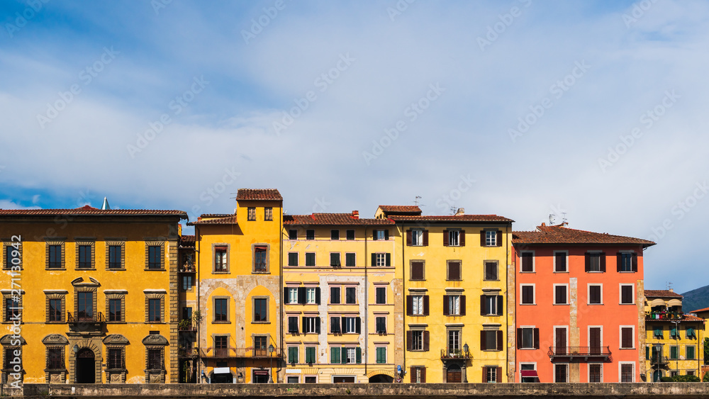 Colorful old Italian houses. Cityscape in Pisa, Italy on a sunny summer day.