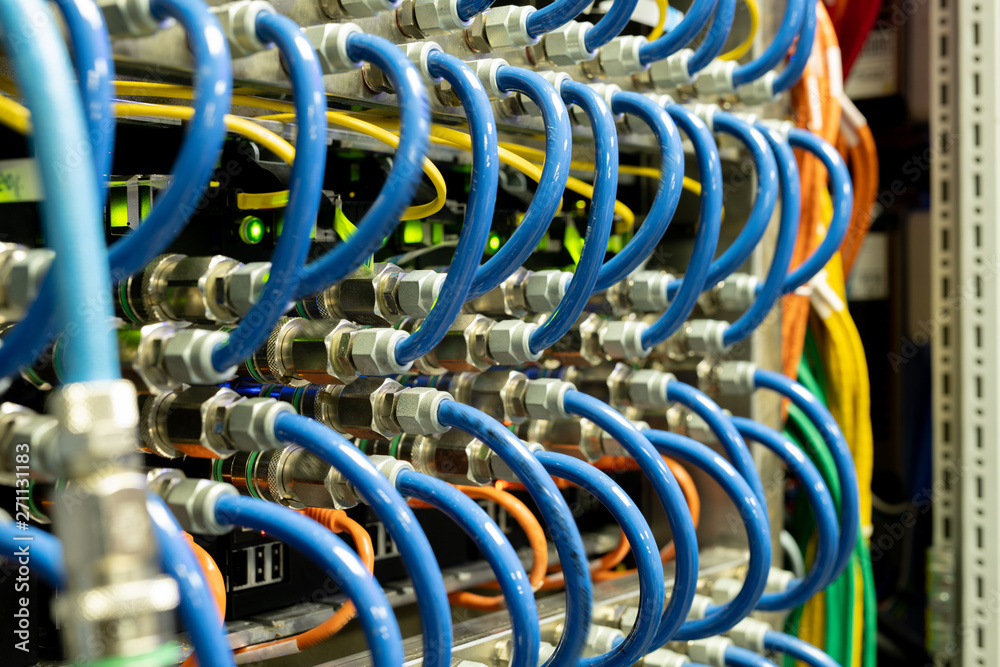 Background image of modern network cables connected in switches in database server room, copy space