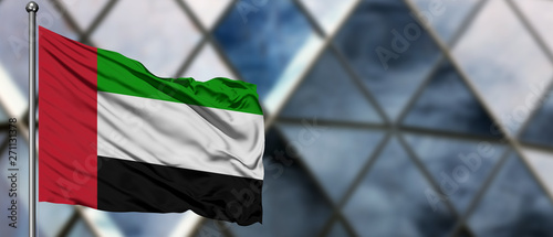 Photography United Arab Emirates flag waving in the wind against blurred modern building