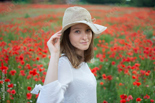 beautiful young woman in a flower field with hat  © Nicolas delafraye