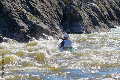 Whitewater kayaking on fast moving water of mountain river among the rapids, extreme water sport. Kayak freestyle on whitewater.