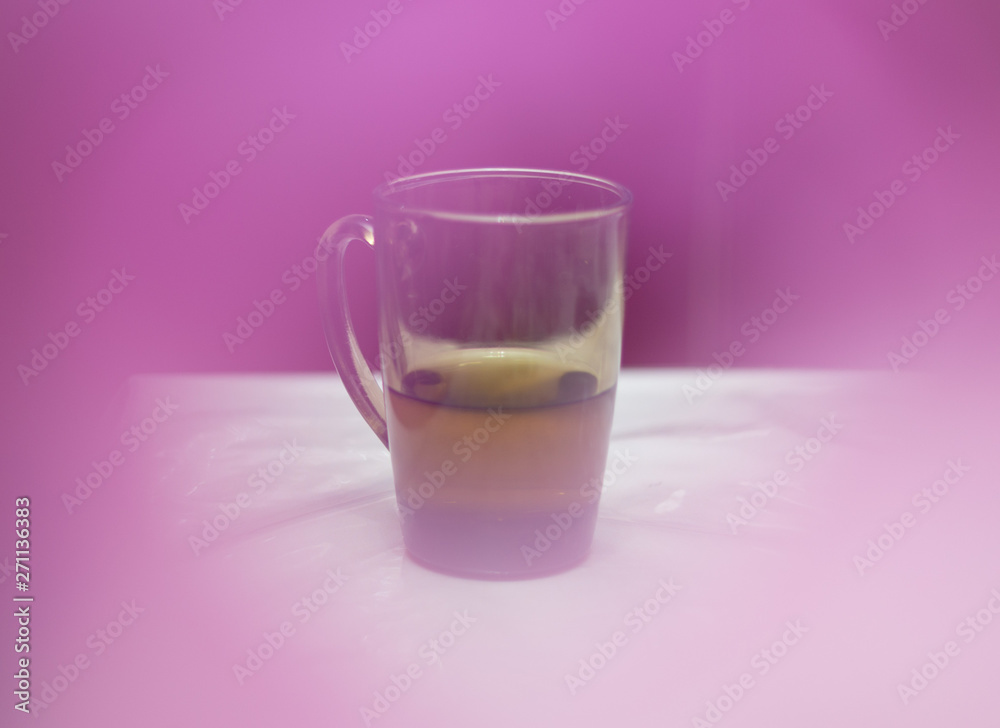 tea in a glass cup on the table, cozy atmosphere on a pink background tea in a glass cup on the table, cozy atmosphere on a pink background
