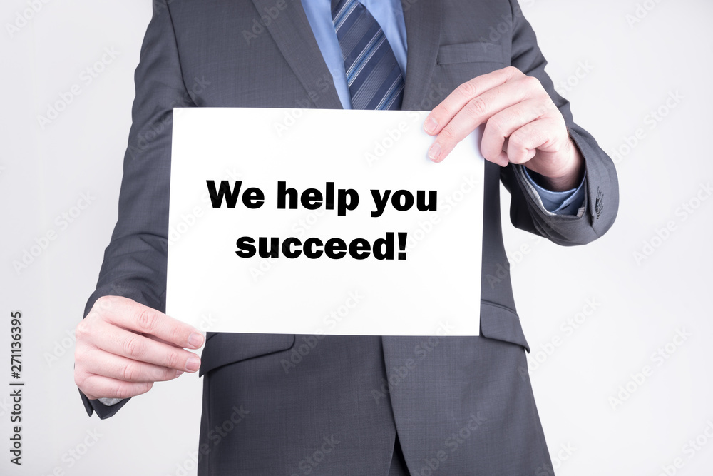 Business man with sign we help you succeed Business man with sign we help you succeed