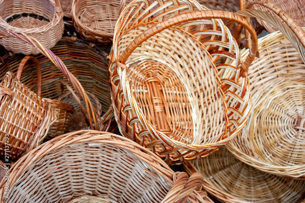 Wicker straw basket close-up. Handmade wicker baskets are sold in the market.
