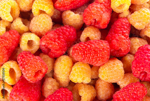 heap of red and yellow raspberries background