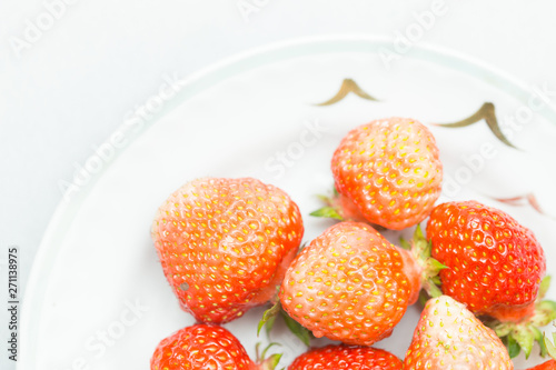 Strawberries on a white background  fresh  tasty and natural strawberries from grandfather s garden on a white plate