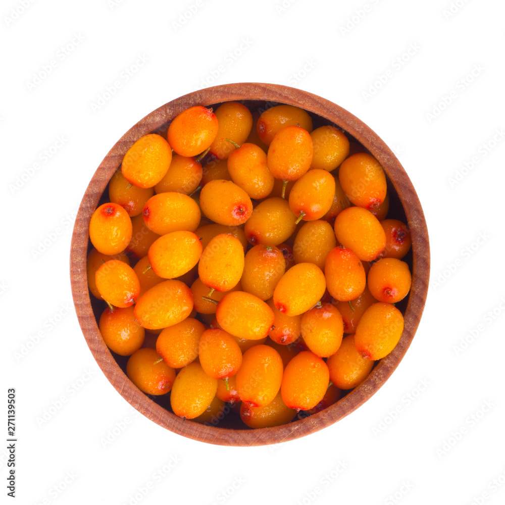 heap of sea buckthorn in wooden cup isolated. top view heap of sea buckthorn in wooden cup isolated. top view