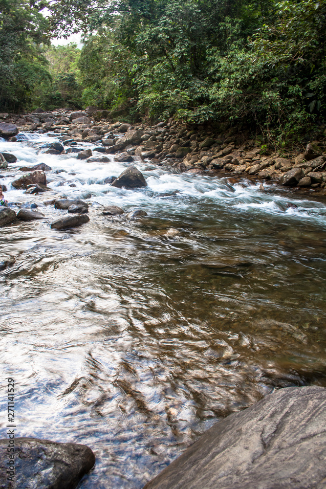 water racing through rocks to Guarau River in Peruibe, Brazil water racing through rocks to Guarau River in Peruibe, Brazil